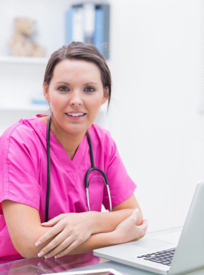 portrait-smiling-nurse-with-laptop-clinic (1) (1)