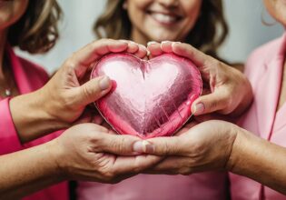 cropped-image-women-holding-pink-heart-hands-charity-event (1) (1)